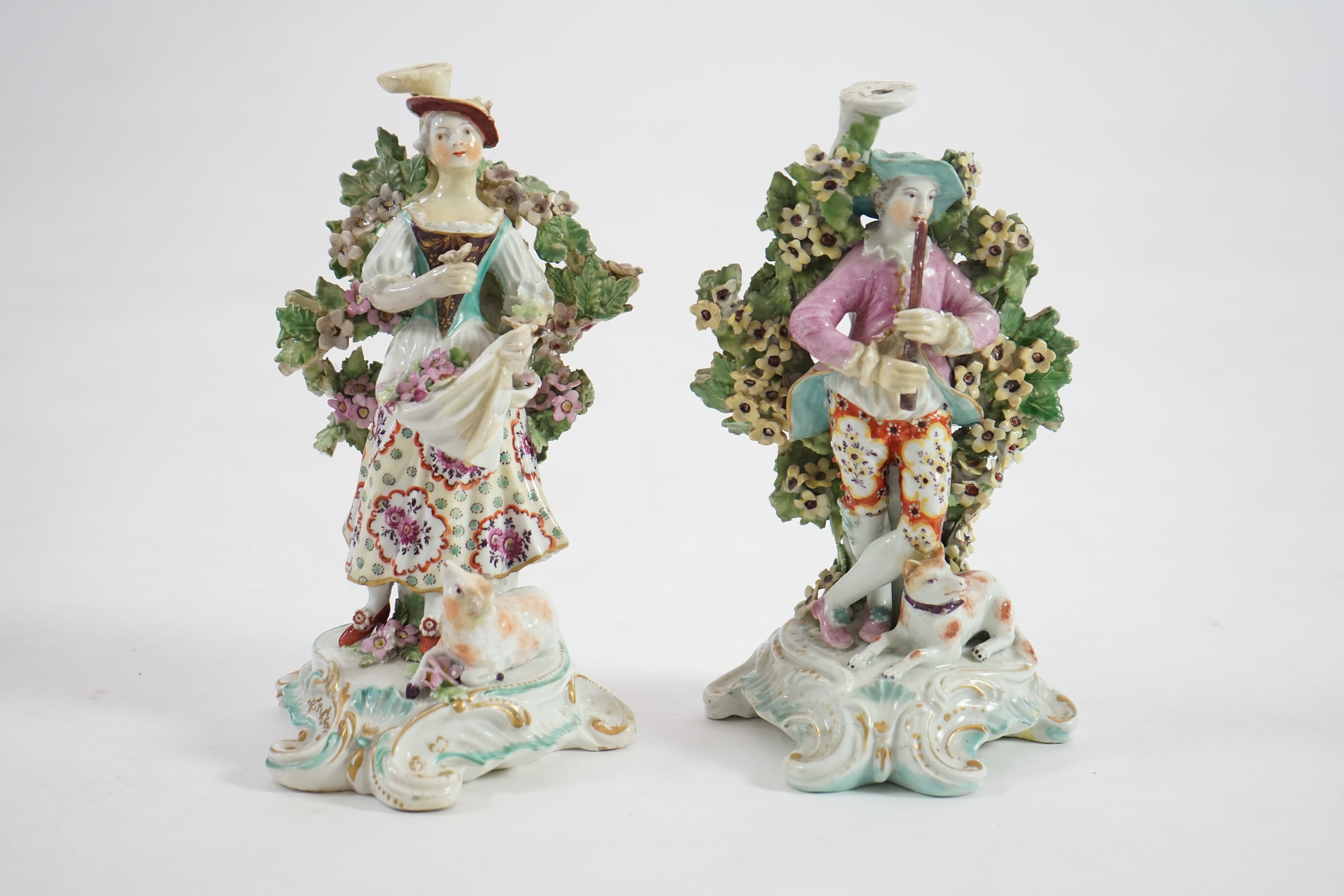 A pair of Derby candlestick groups of a shepherd and shepherdess, c.1775